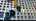 Multicolored, virtual letters appear in front of the Simmons Hall dormitory