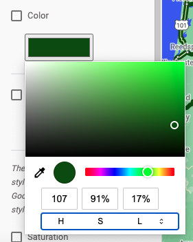 カラー選択ツールを示す詳細なスクリーンショット。上部に長方形の彩度と明度のセレクタがあり、それに続き小さい色相選択ツールがあり、赤、紫、青、緑、黄、オレンジ色のスペクトルが表示されています。その下には色値を入力する数値フィールドがあり、その下にはユーザーが入力する値のタイプ（RGB、HSL、16 進数コード）を選択できるバーがあります。
