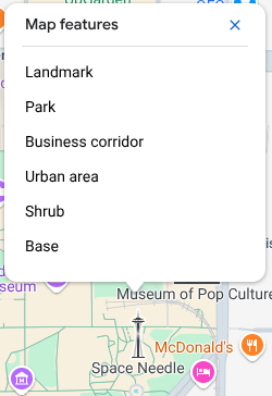 The map inspector opens above the Space Needle and lists six Map Features at that click point: landmark, sports field, business corridor, urban area, shrub, and background.