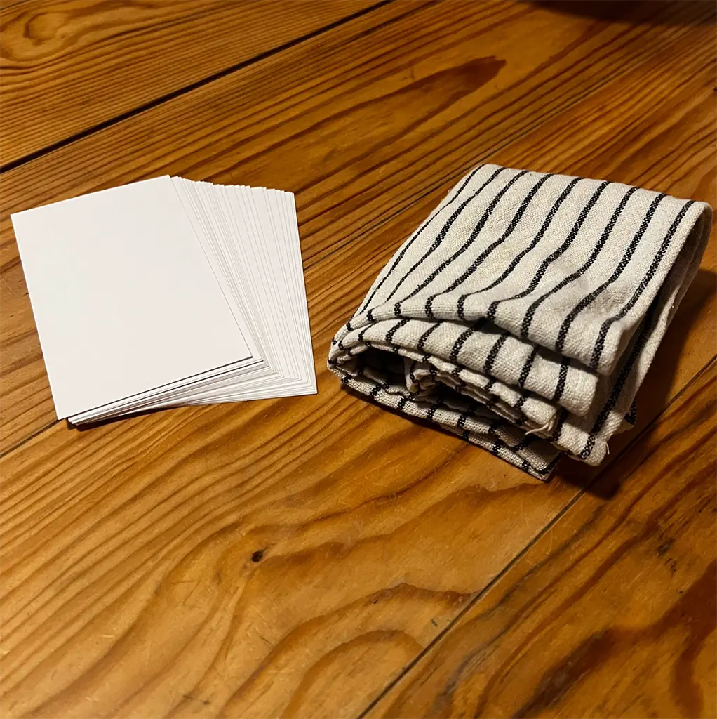 A stack of paper cards and a washcloth. alt_text
